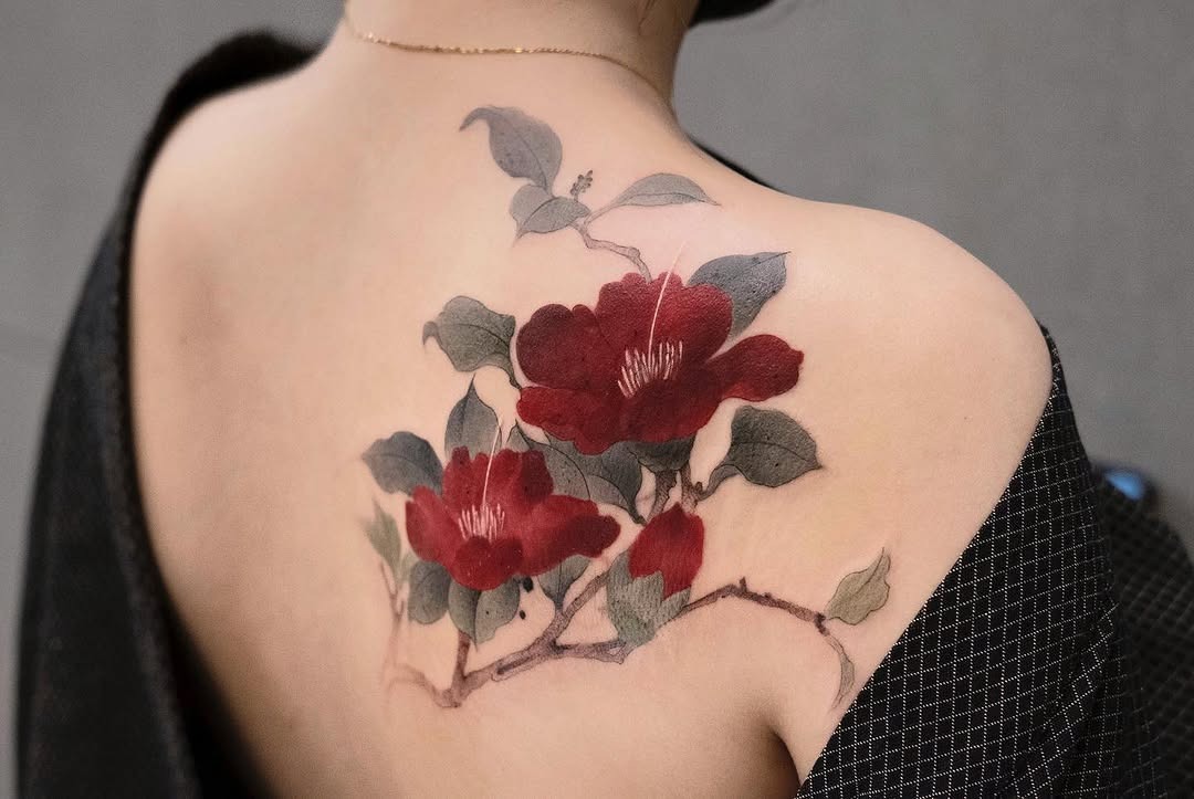 Stunning camellia tattoo on the back Tattoo Design