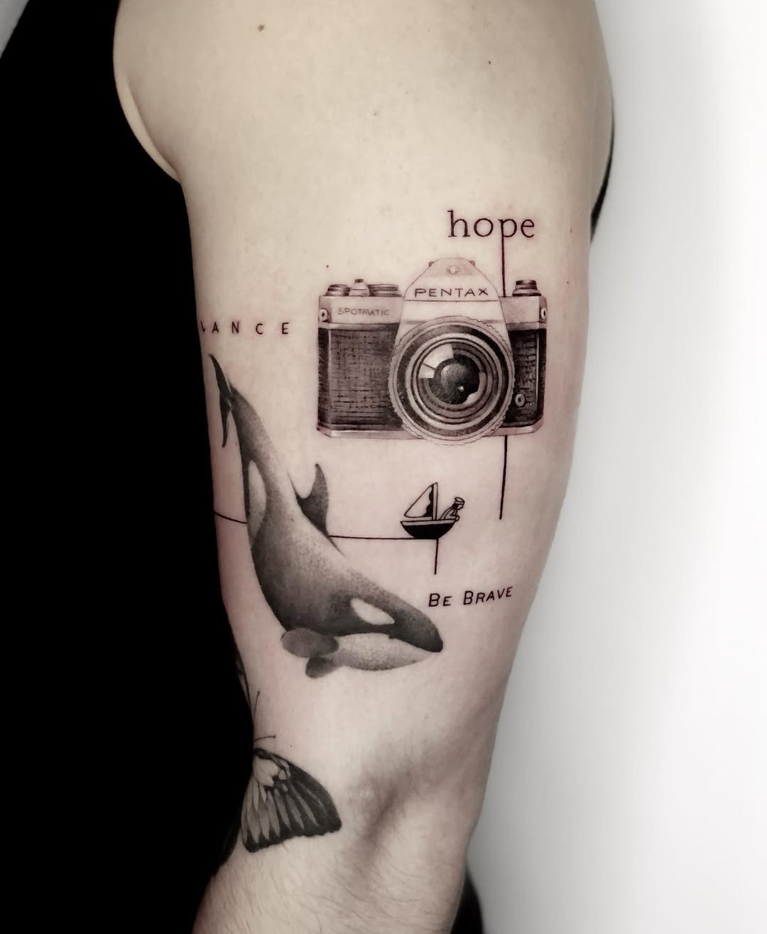 A striking camera tattoo with ocean elements Tattoo Design