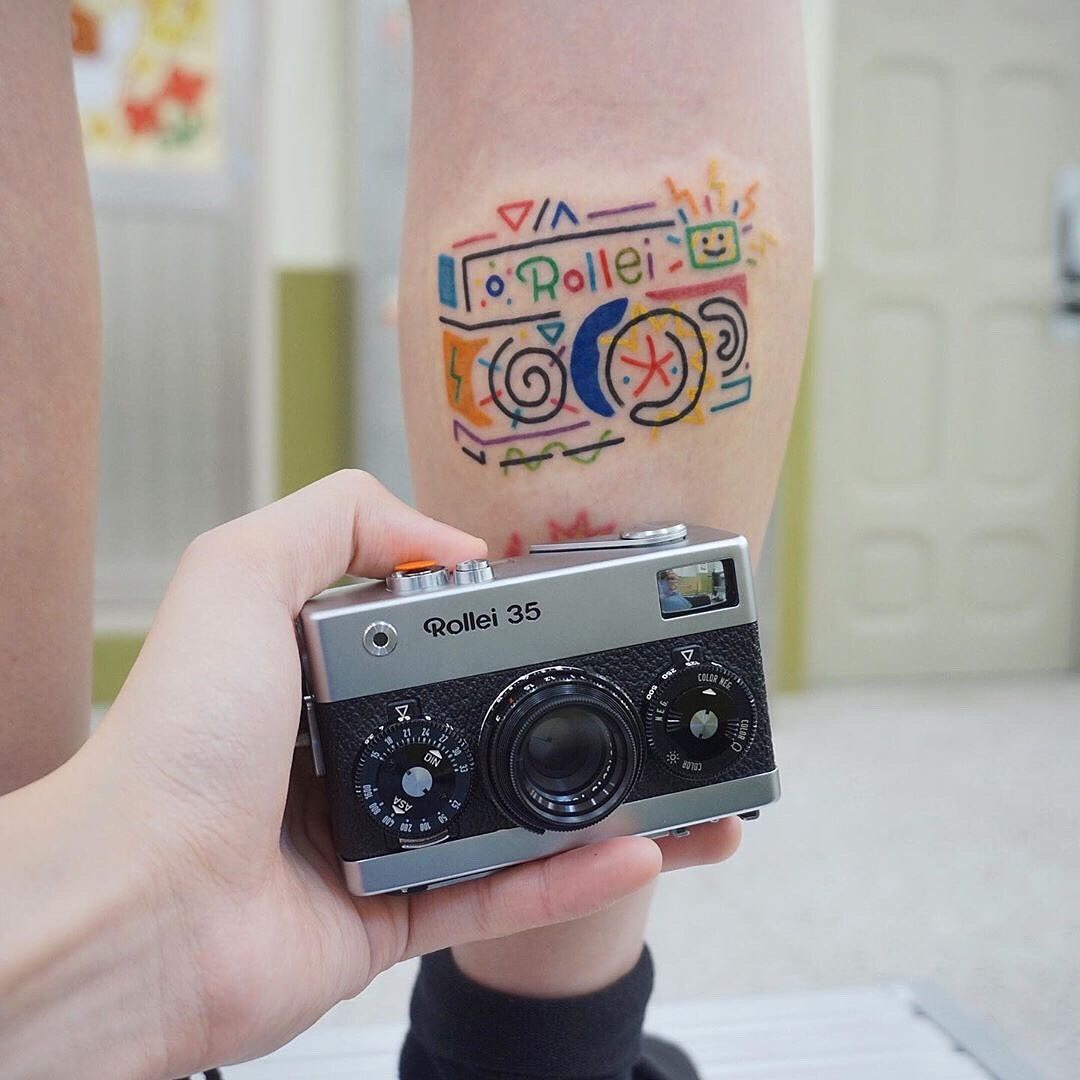 Colorful camera tattoo with playful designs Tattoo Design