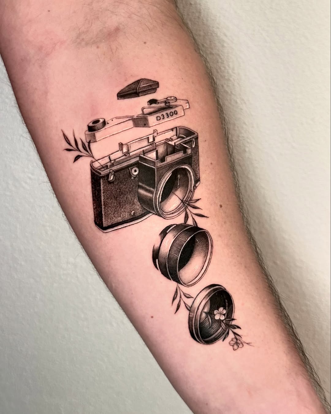 Intricate camera tattoo design with floral elements Tattoo Design