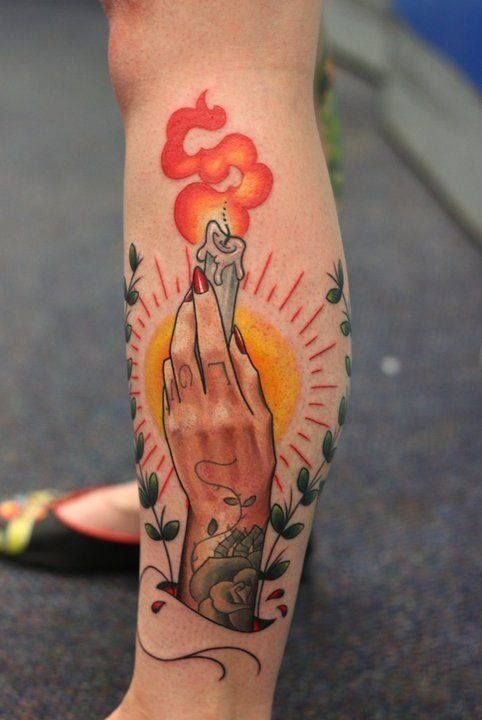 Hand Holding Tiny Lit Candle with Radiant Glow Tattoo Design
