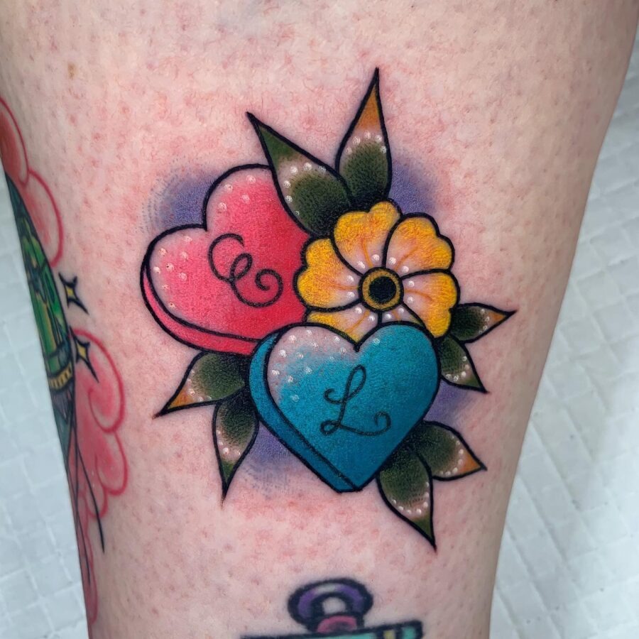 Colorful candy heart tattoo with floral accents Tattoo Design