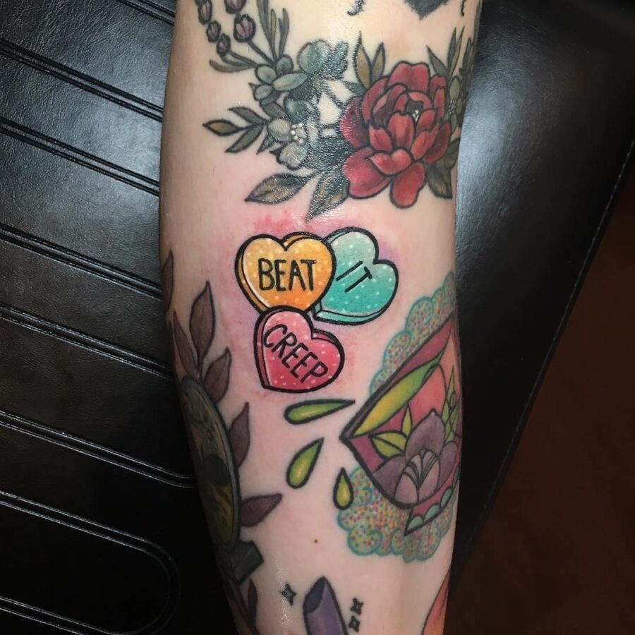 Whimsical candy heart tattoos with bold messages Tattoo Design