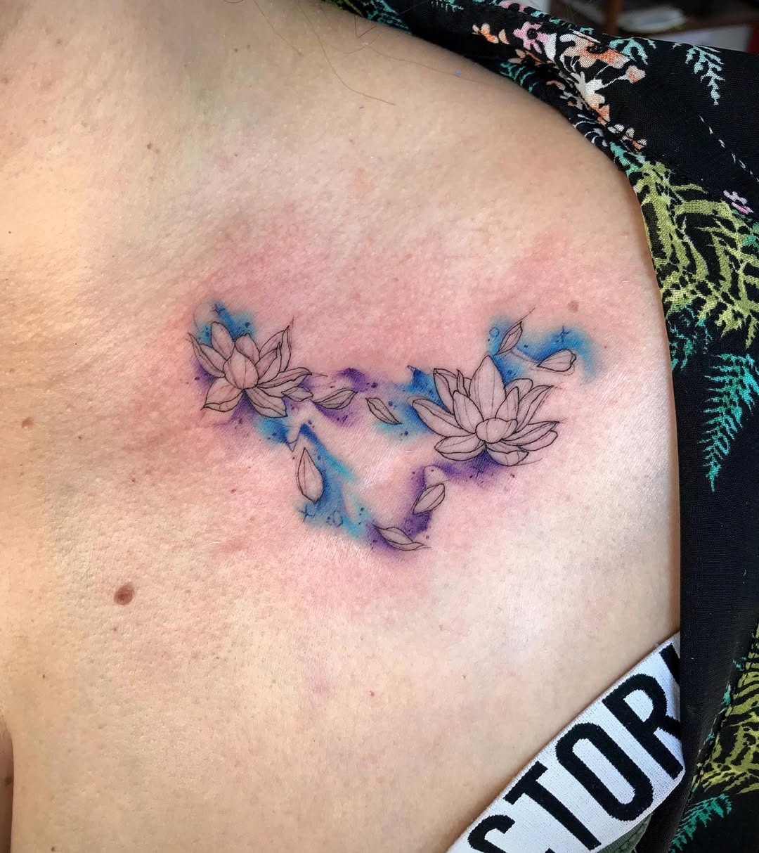 This tattoo combines the graceful beauty of lotus flowers with colors.