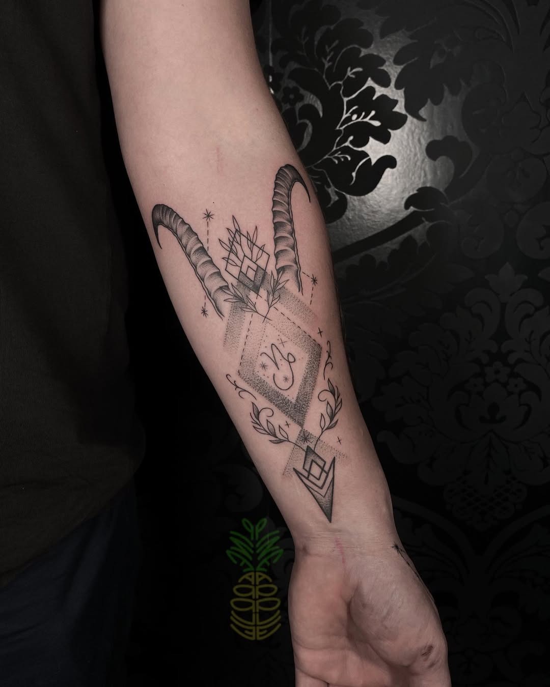 This Capricorn tattoo features striking horns and geometric shapes, creating a uniquely bold design.