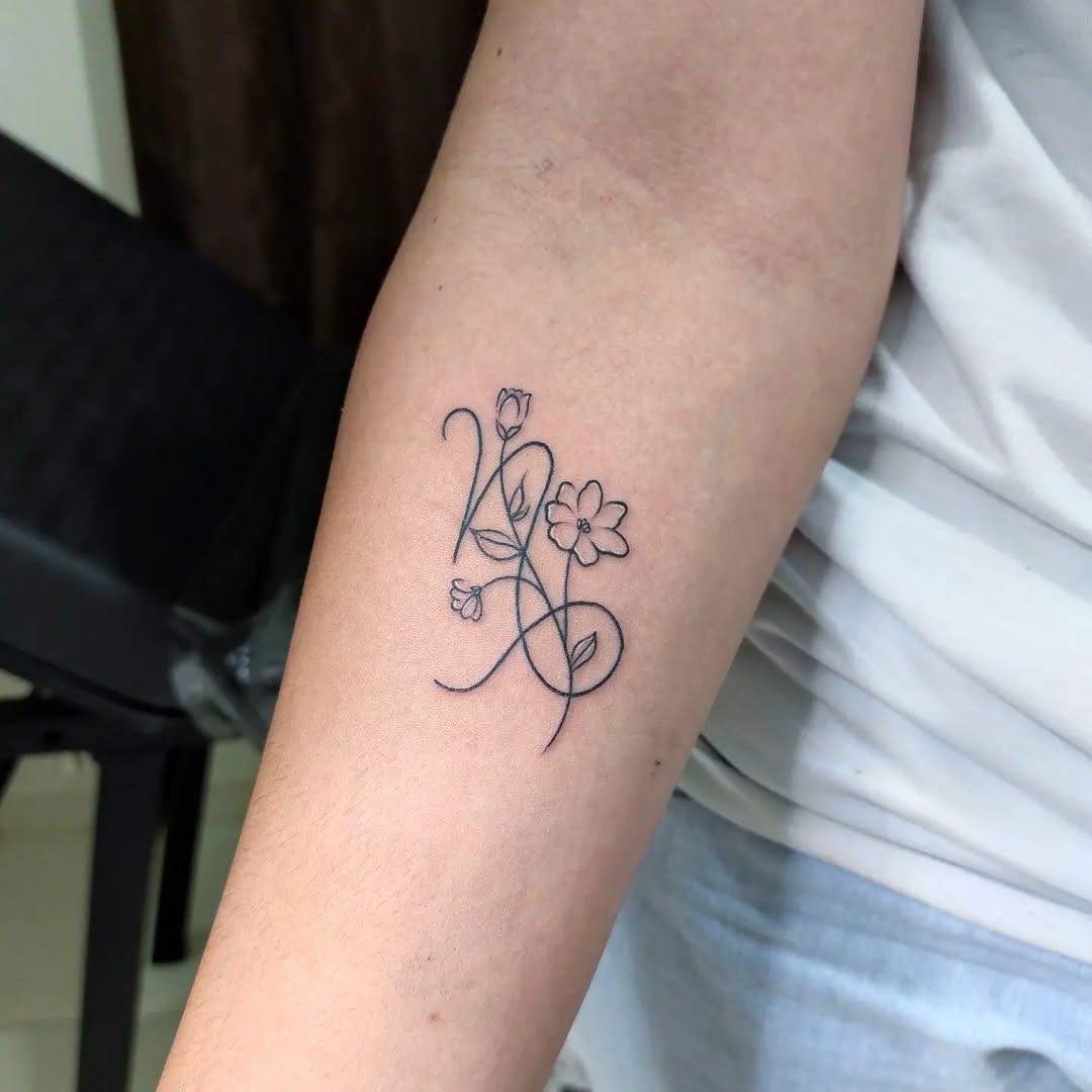 This minimalist Capricorn tattoo features delicate flowers intertwined with the zodiac symbol.