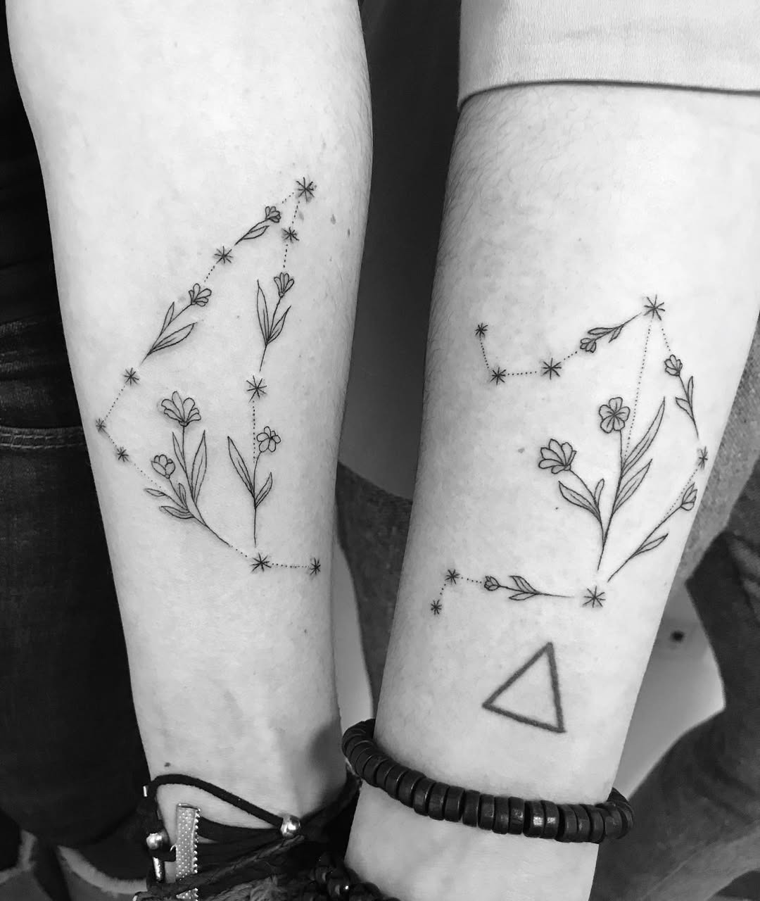 These minimalist Capricorn tattoos blend floral elements with constellation art.