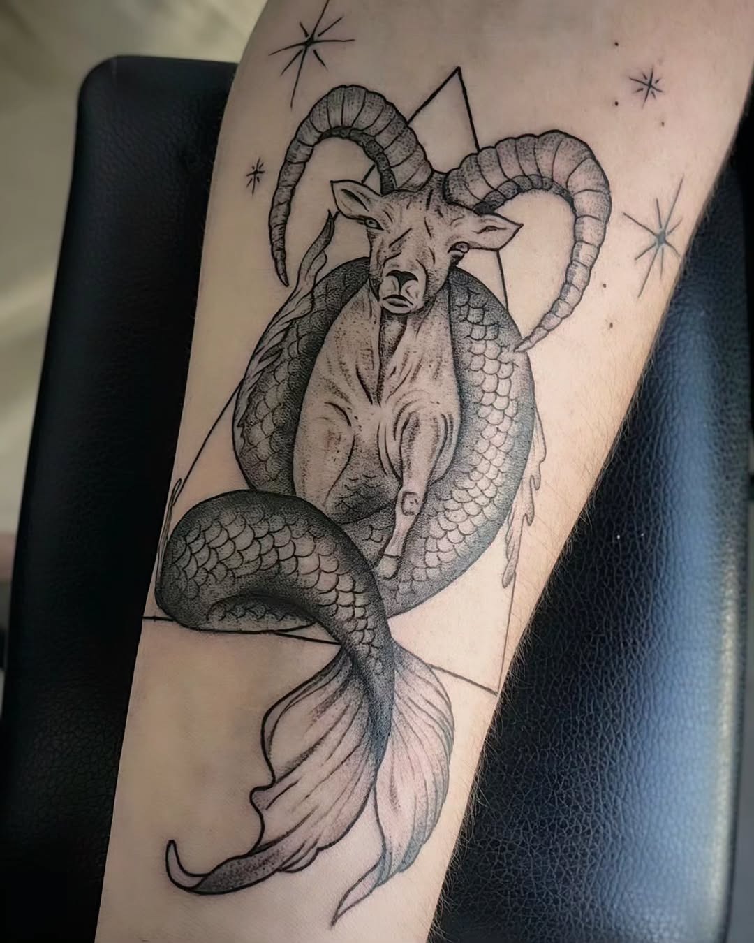 This tattoo harmoniously incorporates the Capricorn's goat and mermaid elements, creating a mythical vibe.
