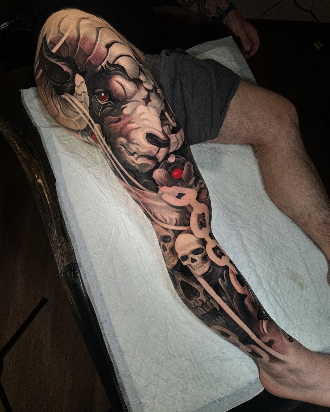 This tattoo features a stunning representation of Capricorn, intricately blended with elements like skulls and snakes.