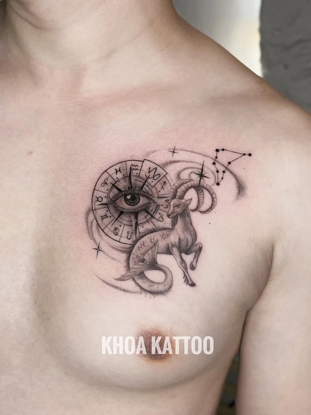 This Capricorn tattoo features a detailed ram intertwined with an artistic eye and astrological symbols.