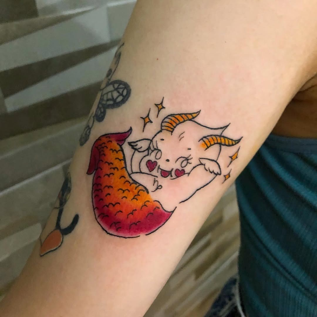 This tattoo showcases a whimsical depiction of a Capricorn as a cute mermaid, complete with colors and playful accents.
