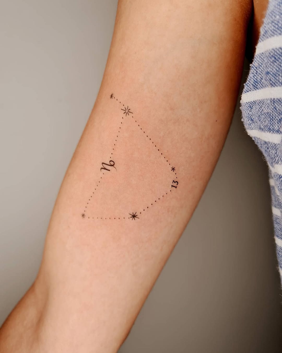 This Capricorn constellation tattoo showcases delicate lines and stars, emphasizing clarity and subtlety.