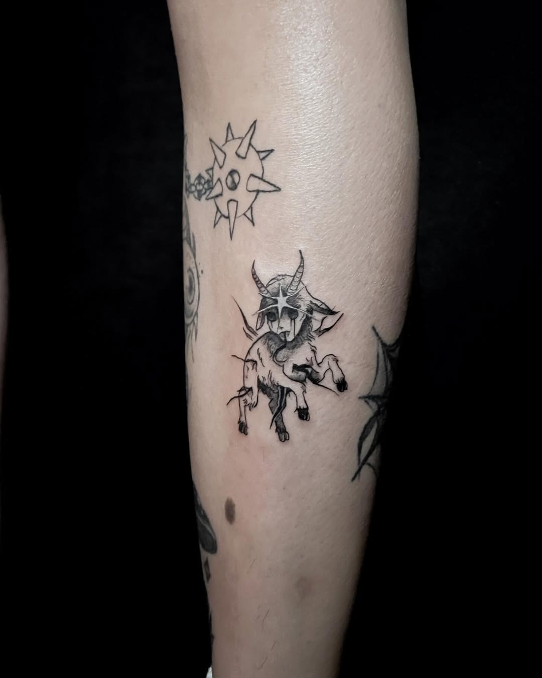 This unique Capricorn tattoo showcases a minimalist style featuring the iconic goat of astrology.