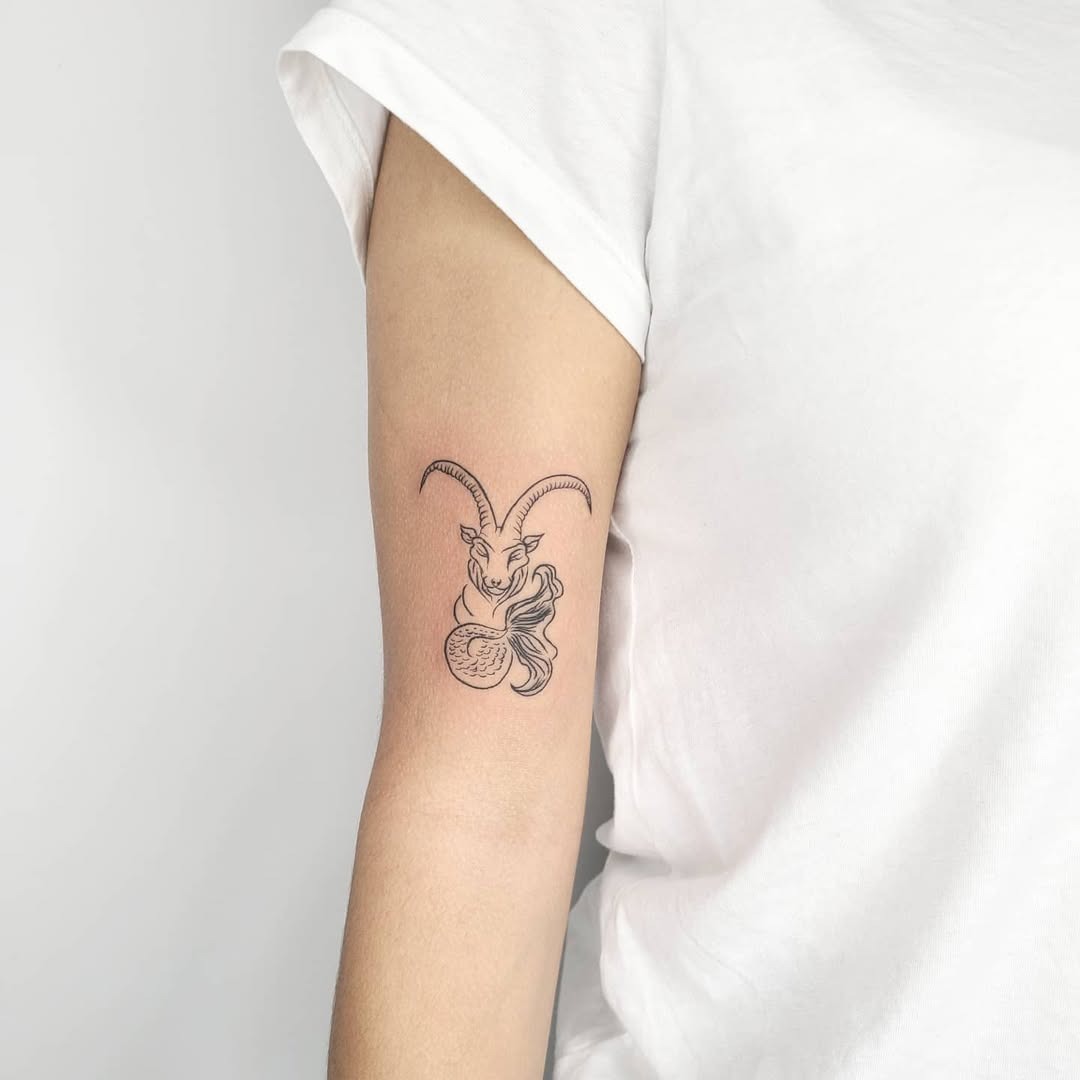 This Capricorn tattoo features a graceful goat intertwined with flowing lines, creating a charming and mystical vibe.