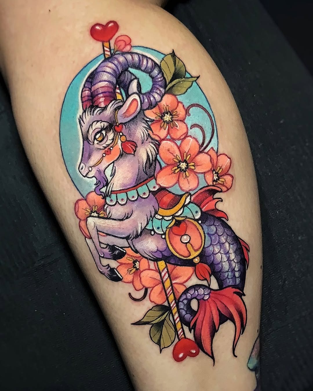 This eye-catching Capricorn tattoo features a whimsical depiction of a goat entwined with beautiful flowers.