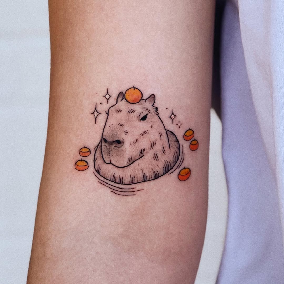 Adorable capybara tattoo with citrus accents Tattoo Design