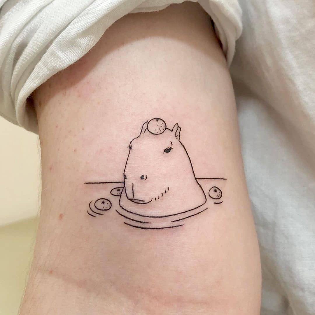 Charming capybara in a tranquil pool design Tattoo Design