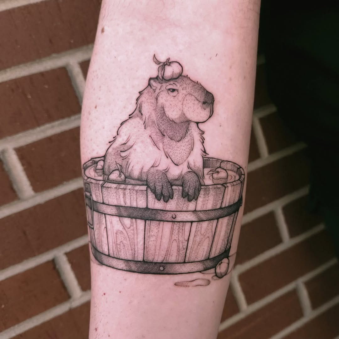 Charming capybara tattoo in a wooden bucket Tattoo Design