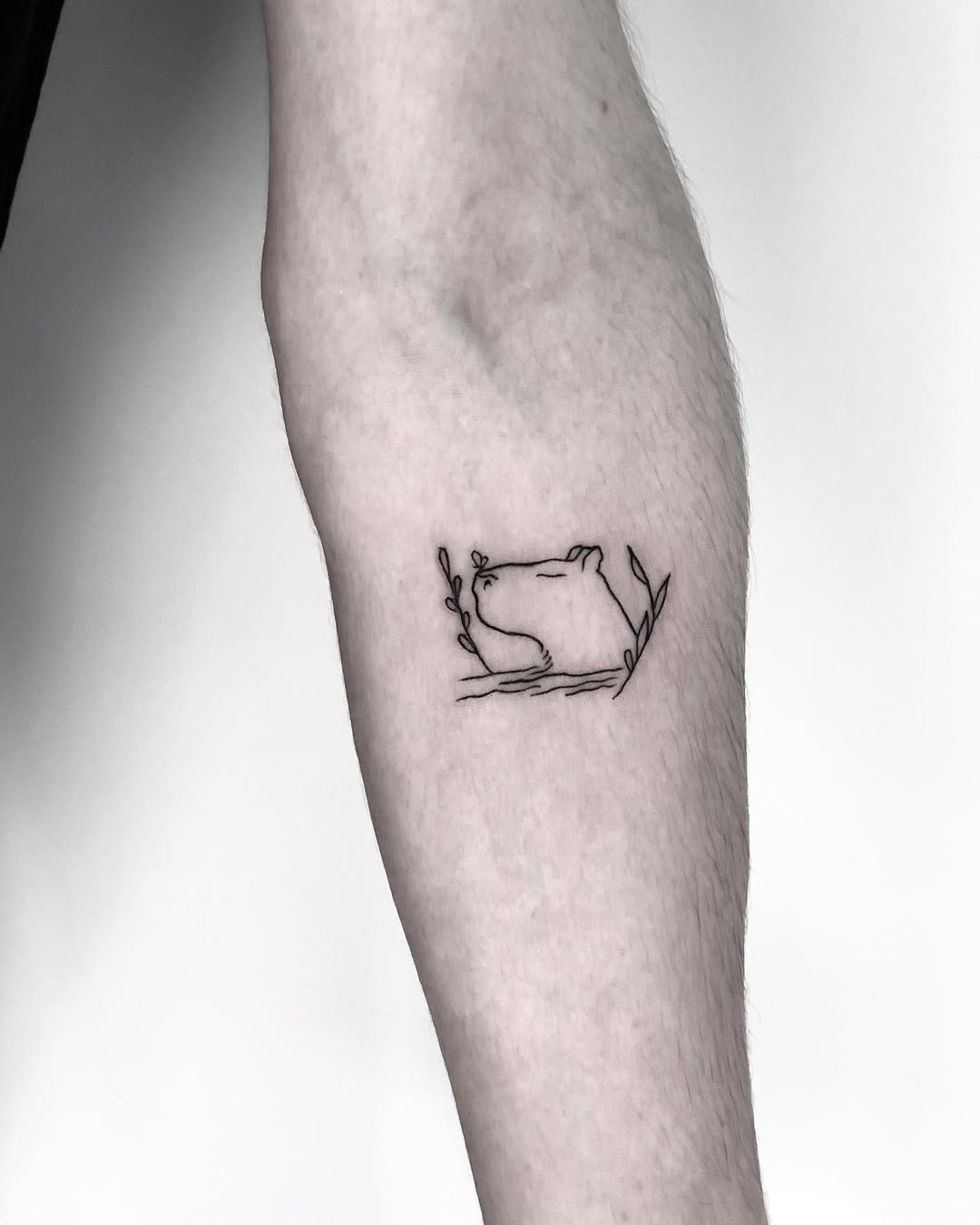 Elegant line art capybara tattoo surrounded by foliage Tattoo Design