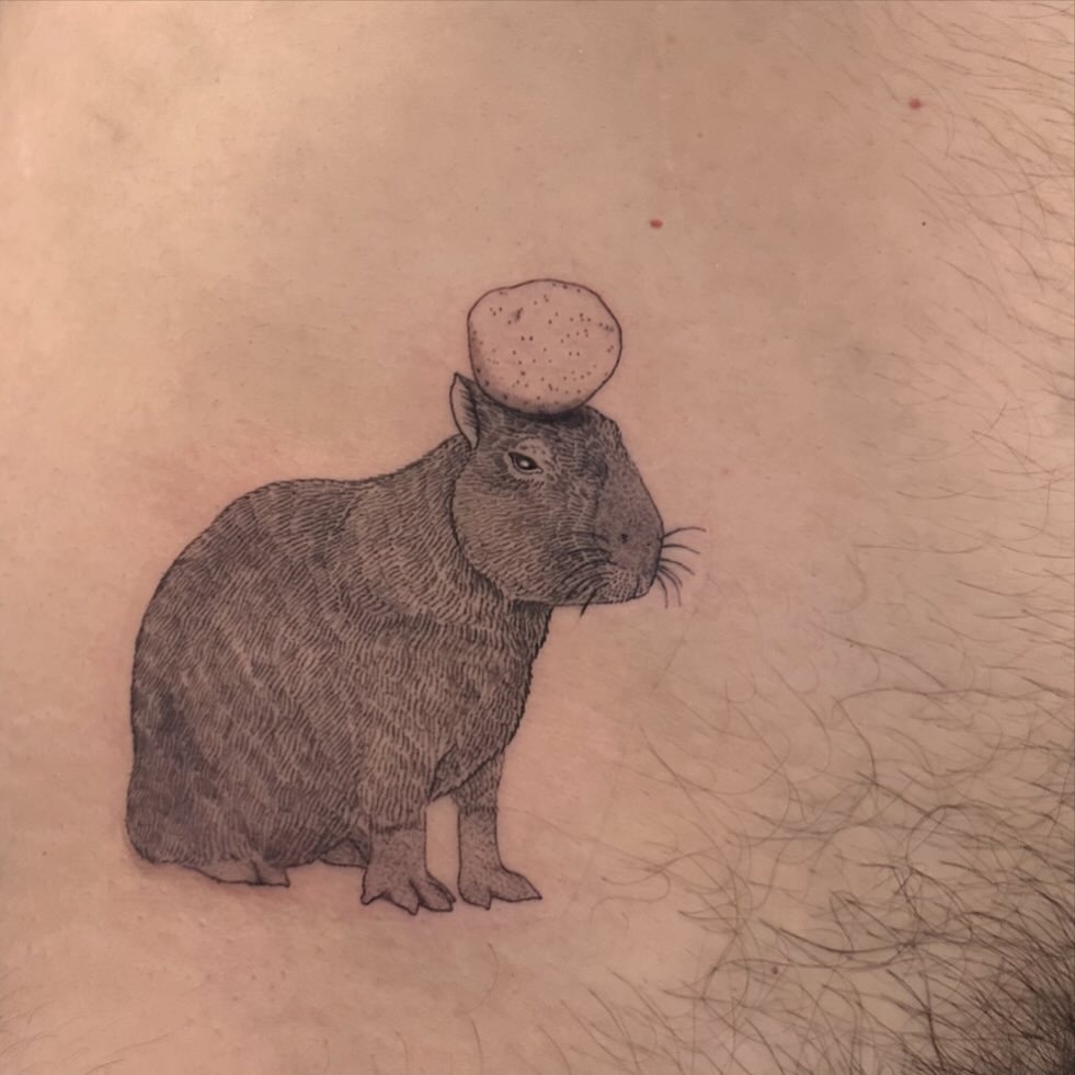 Quirky capybara tattoo with an egg on top Tattoo Design