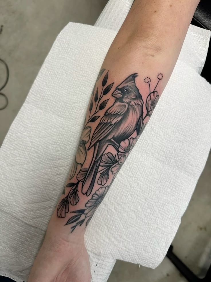Black and Grey Cardinal with Botanical Details Tattoo Design