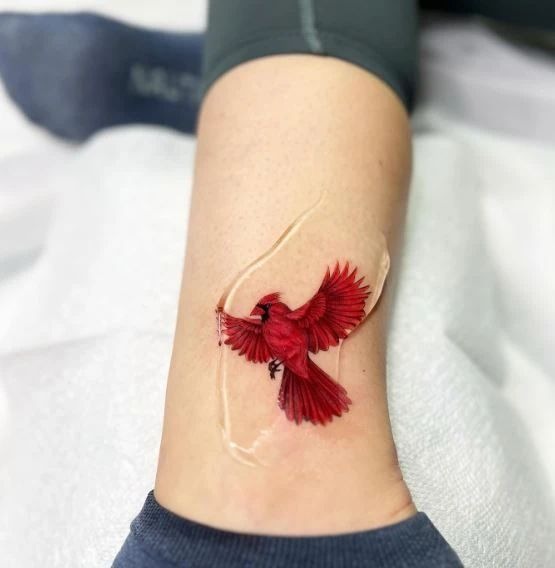 Tiny Realistic Cardinal in Flight Tattoo Design