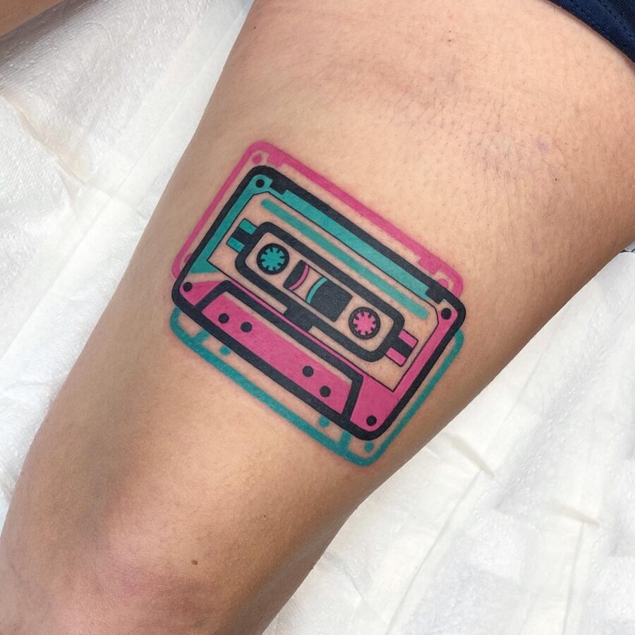 This stunning cassette tape tattoo features bright colors, merging retro charm with contemporary art.