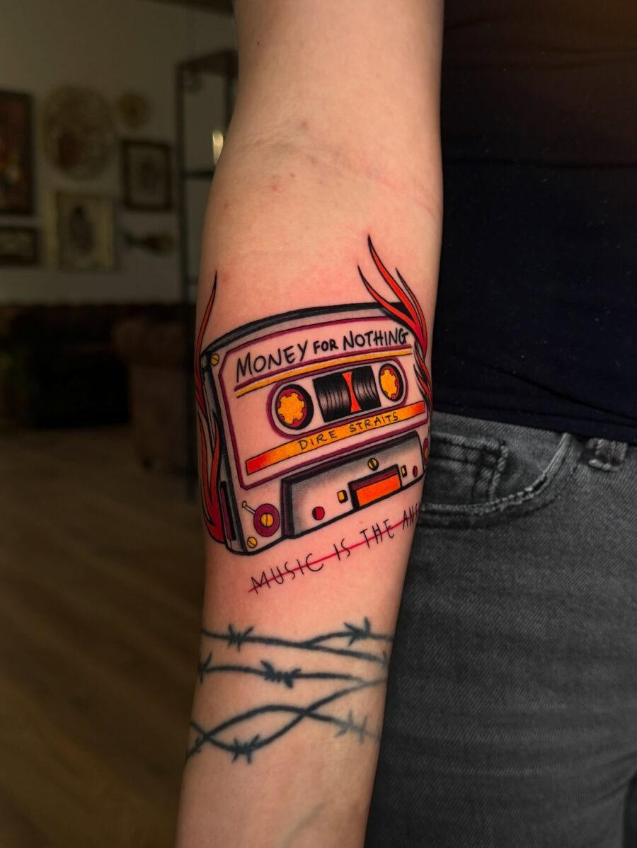 This cassette tape tattoo showcases the iconic 'Money for Nothing' design.