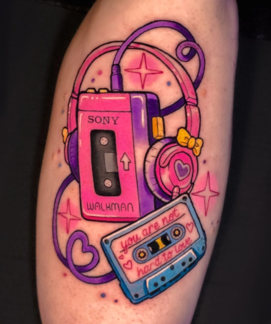 This tattoo features a nostalgic Walkman paired with a cassette, exuding retro vibes.