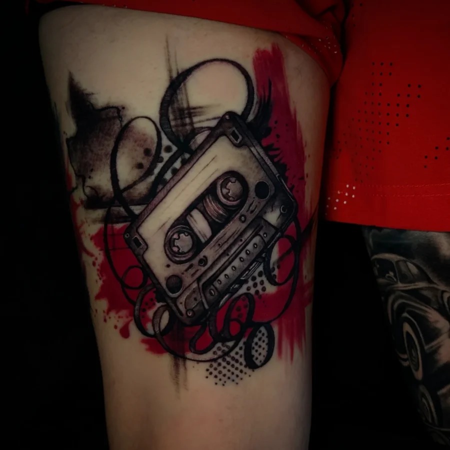 This ink design features a classic cassette tape in striking black and red tones.