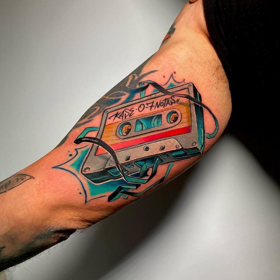 This cassette tape tattoo captures retro vibes with bold, bright colors and intricate details.