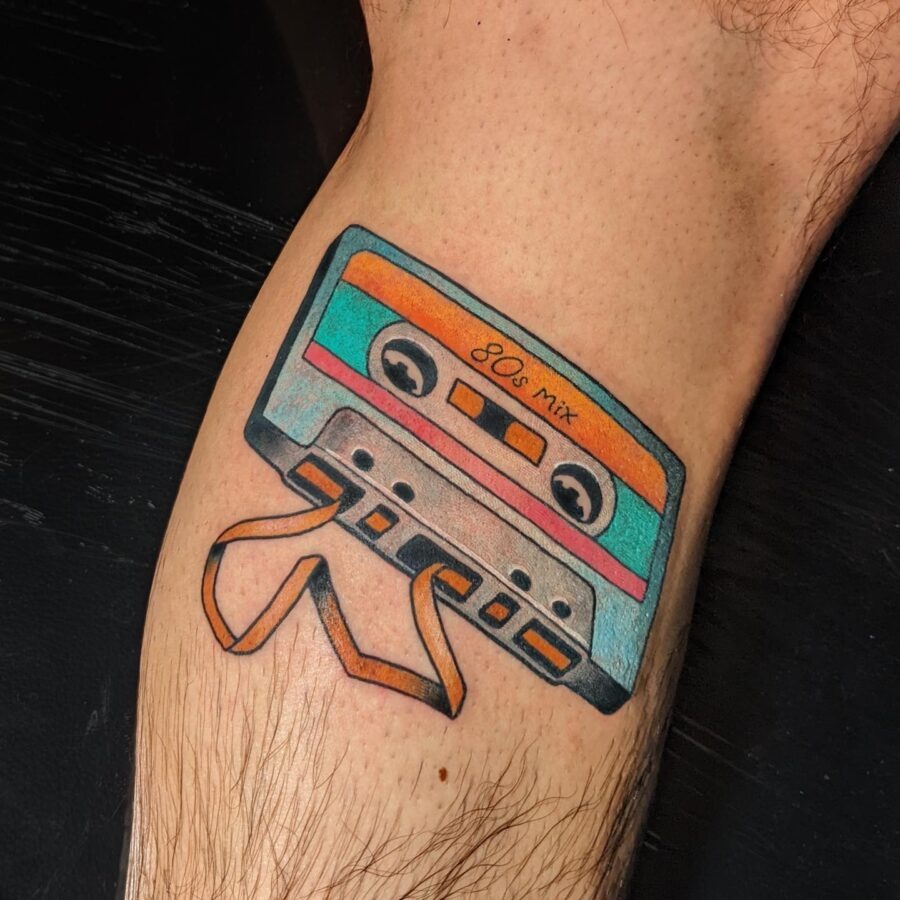 This colorful tattoo features a retro cassette tape labeled '80s mix,' showing teal and orange colors.