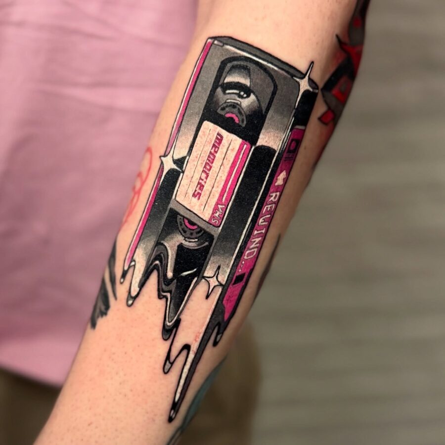 This tattoo features a colorful cassette tape, complete with a 'Rewind' label.