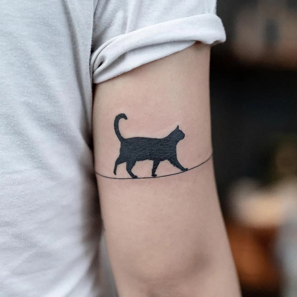 Minimalist Walking Cat Silhouette Tattoo - Simple and Elegant Tattoo Design