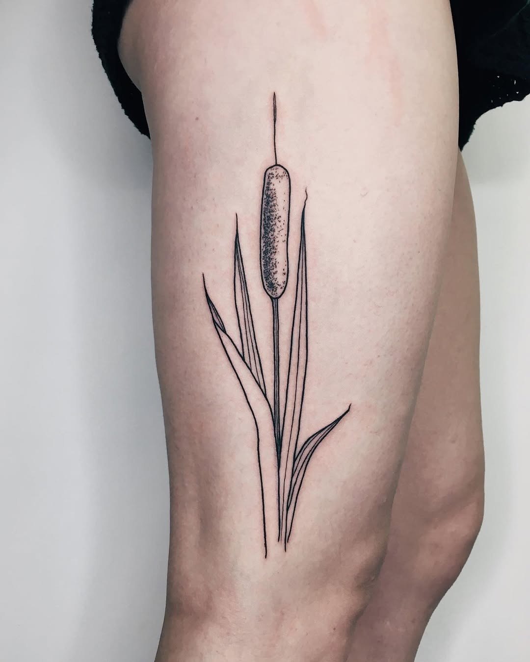 This cattail tattoo features a simple yet elegant design, showing the beauty of nature.