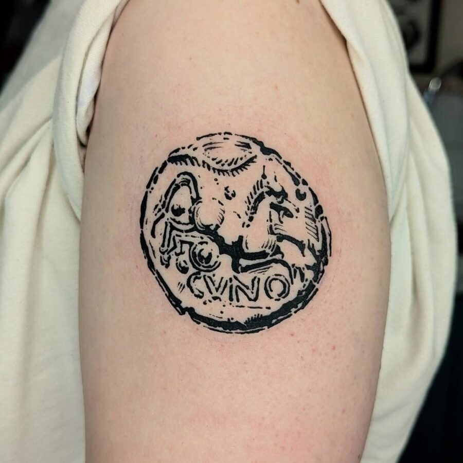Intricate Celtic coin tattoo design in black ink Tattoo Design