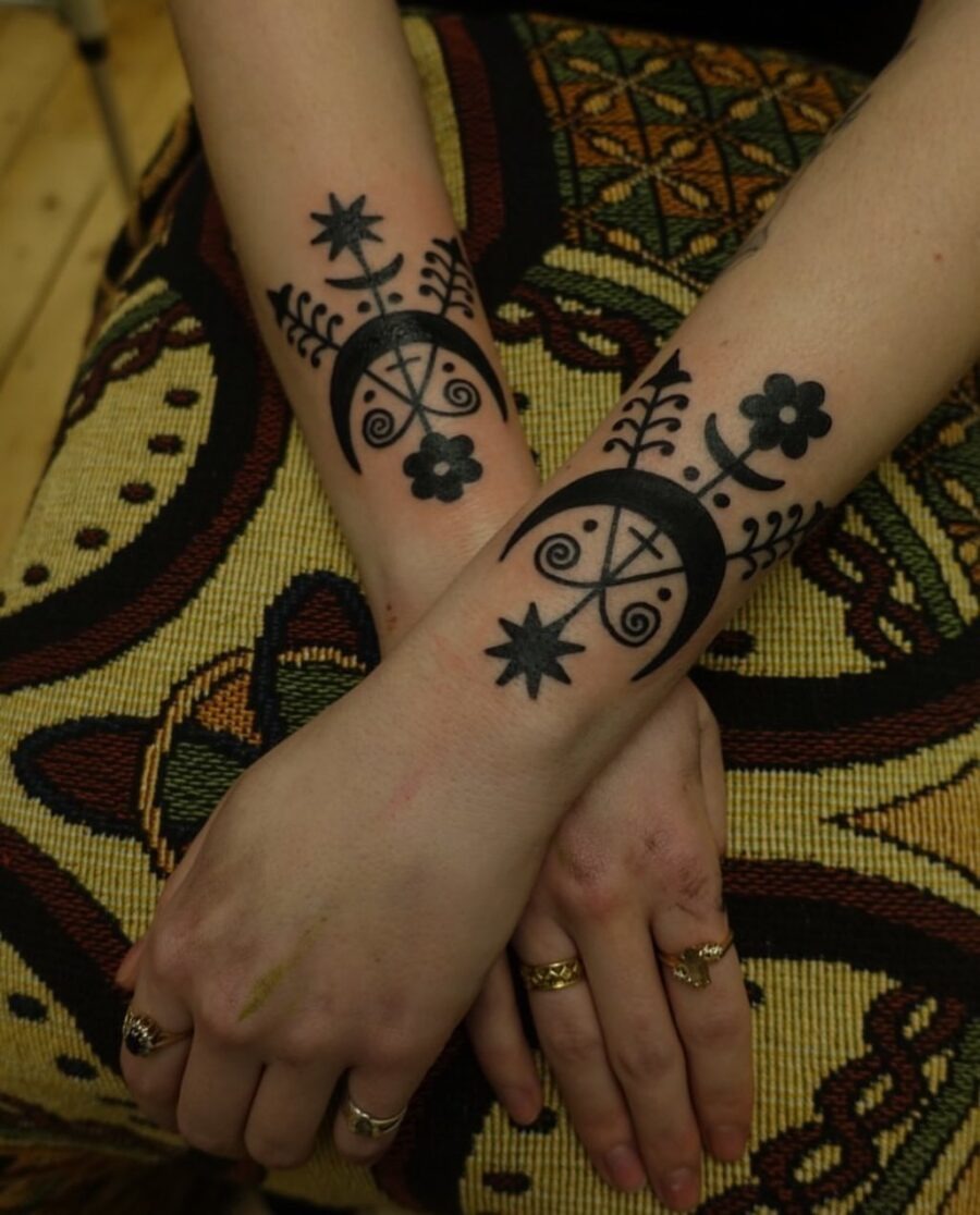 Stunning Black Ink Celtic Symbols on Forearms Tattoo Design