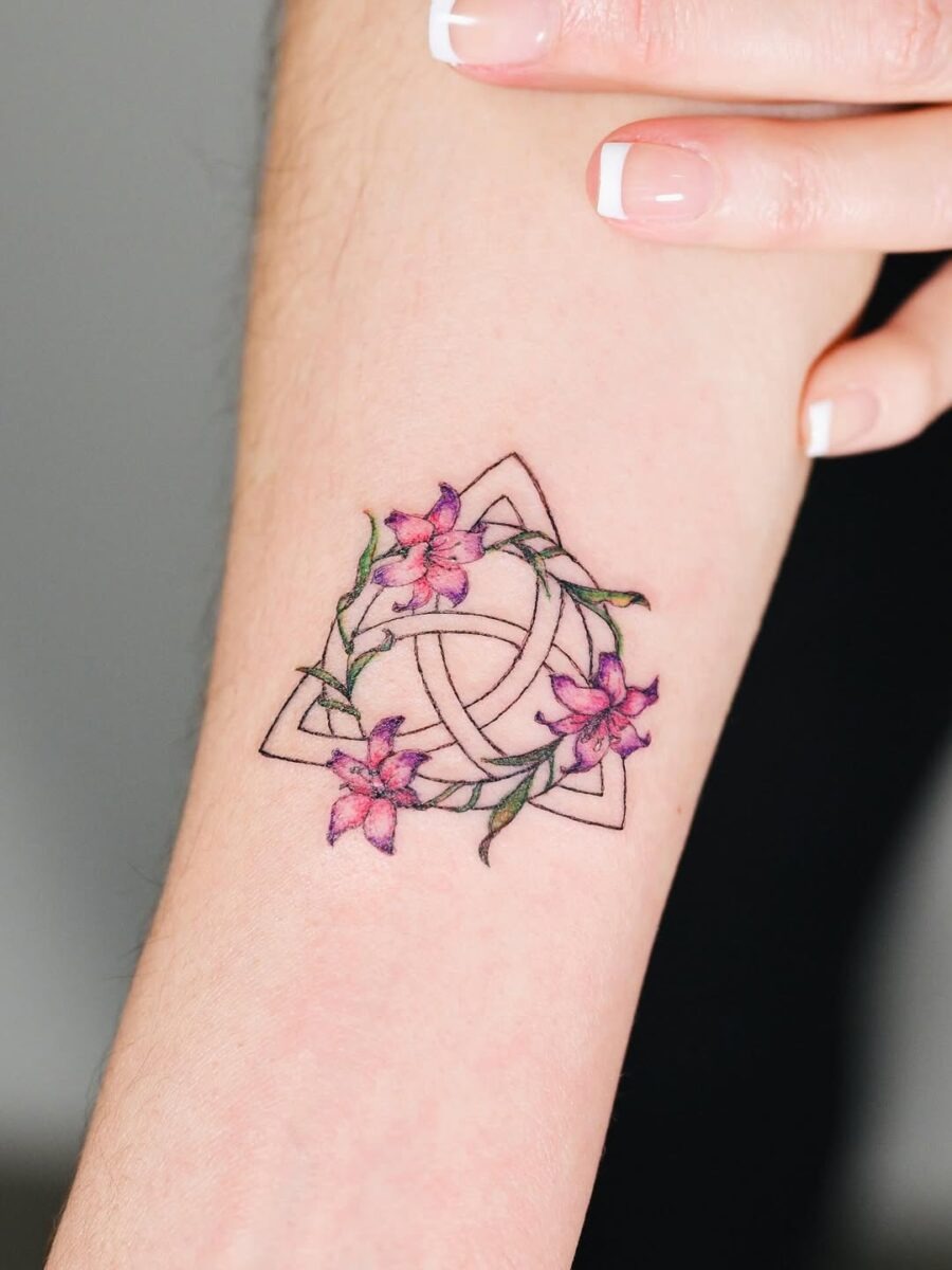 Trinity knot with floral embellishments Tattoo Design