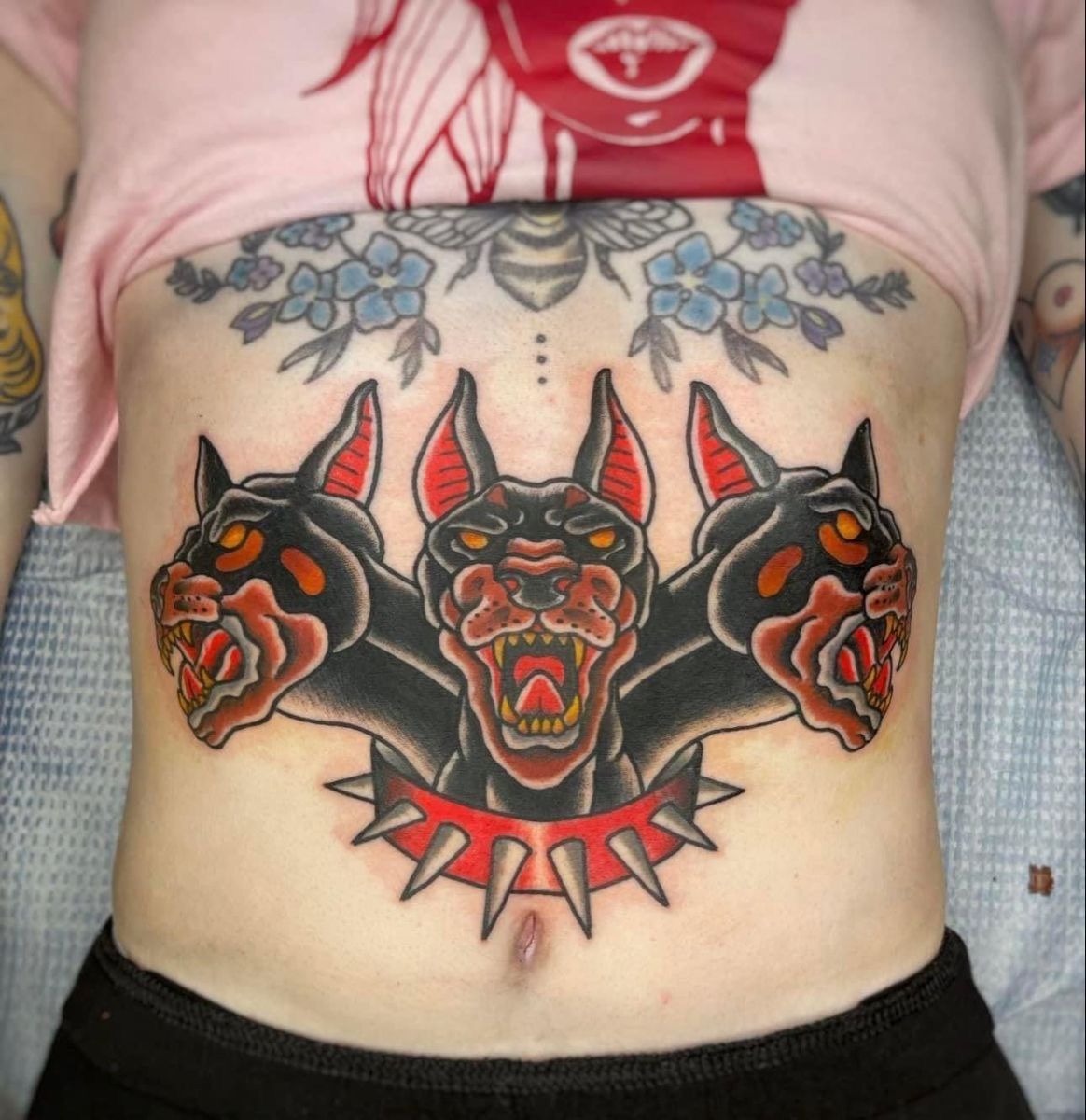 Playful Trad Cerberus With Color Pop Tattoo Design