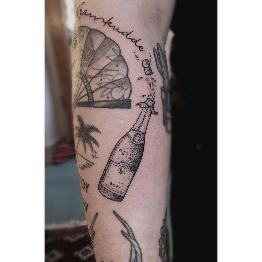 A stylish champagne bottle tattoo for celebration Tattoo Design