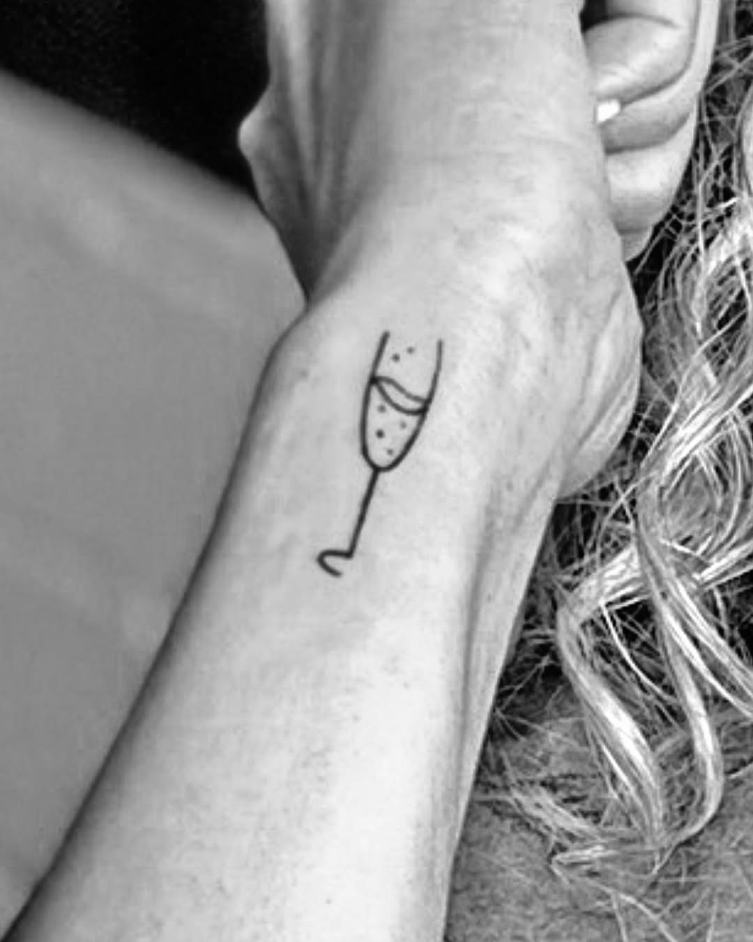 Chic champagne glass tattoo on the wrist Tattoo Design