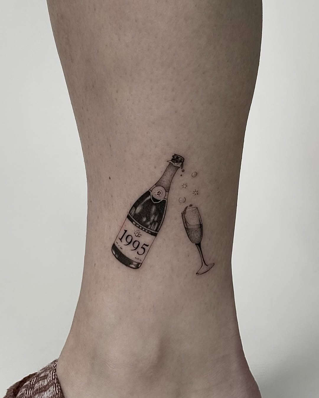 Chic champagne tattoo with a festive vibe Tattoo Design