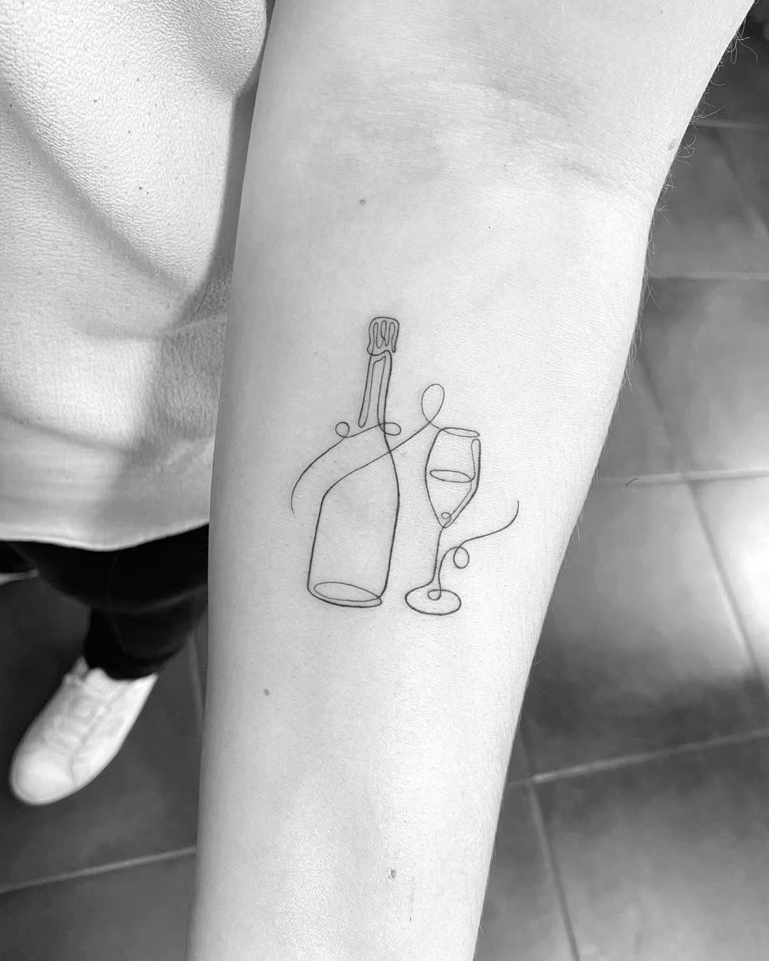 Elegant line art champagne bottle and glass tattoo Tattoo Design