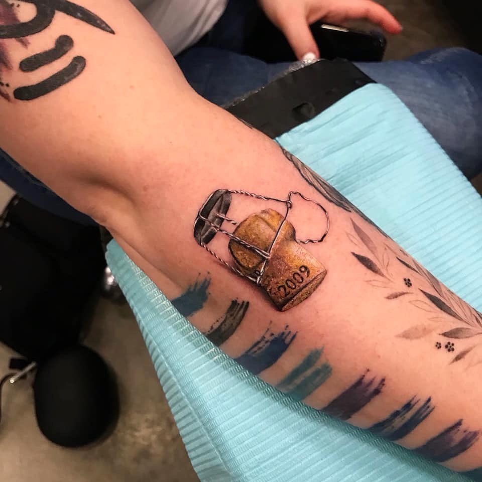 Unique champagne cap tattoo with a vintage touch Tattoo Design