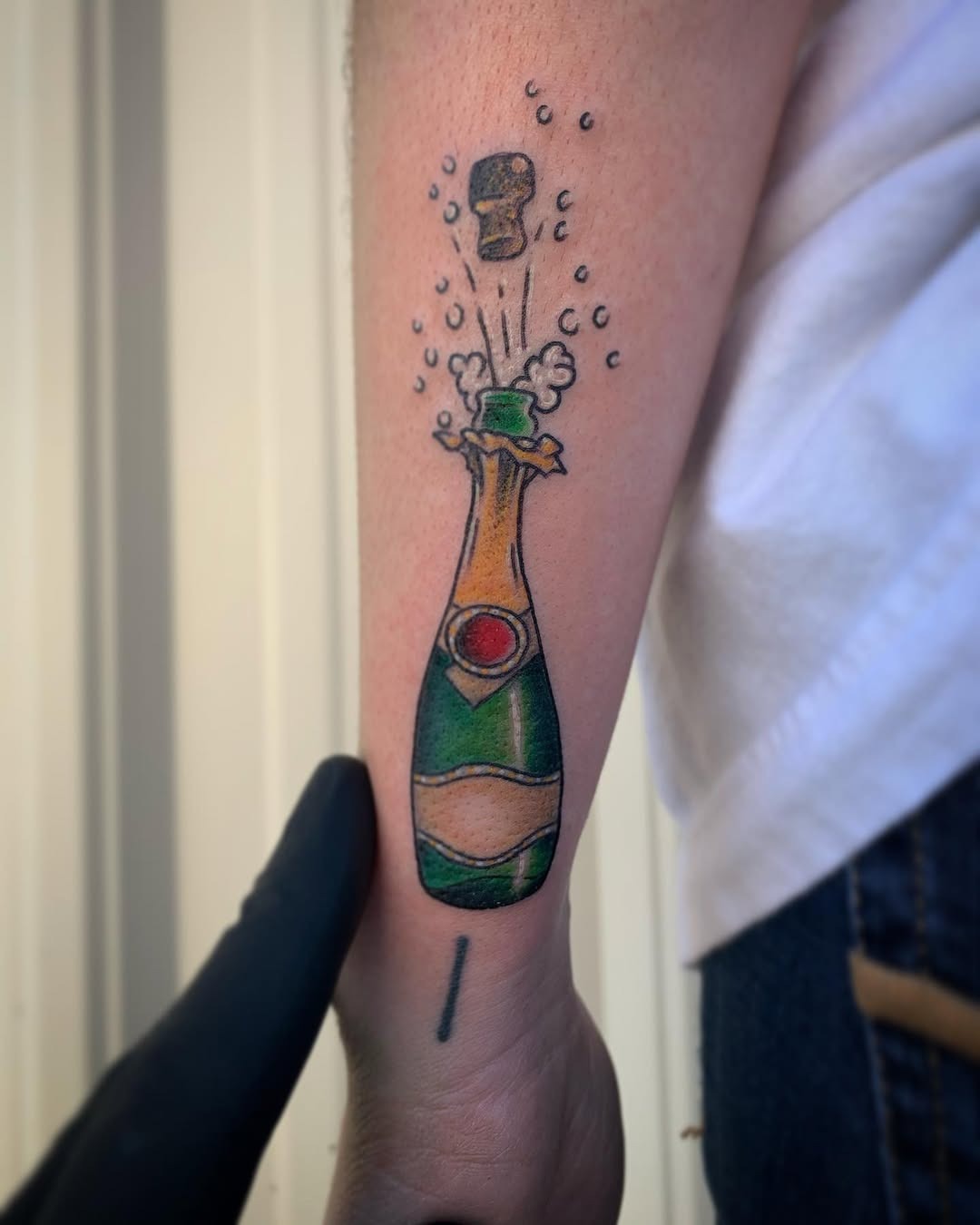 Vibrant champagne bottle tattoo with bubbles Tattoo Design