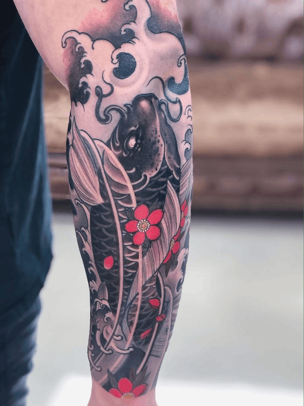 The Rising Koi Fish with Blossoms Tattoo Design
