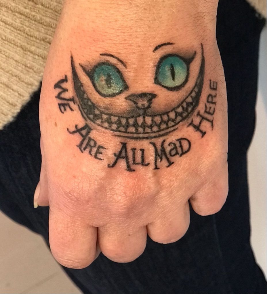 Cheshire Cat Hand Smile Tattoo With Quote Tattoo Design