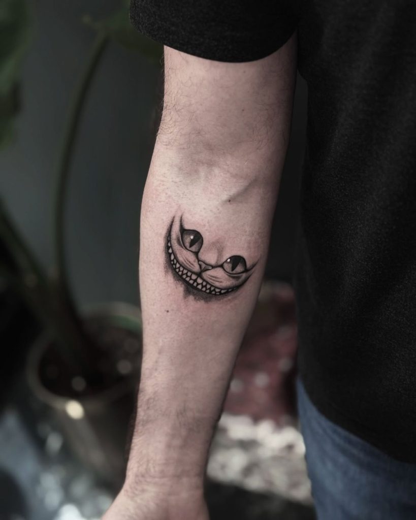 Minimalist Blackwork Cheshire Cat Smile Tattoo Design