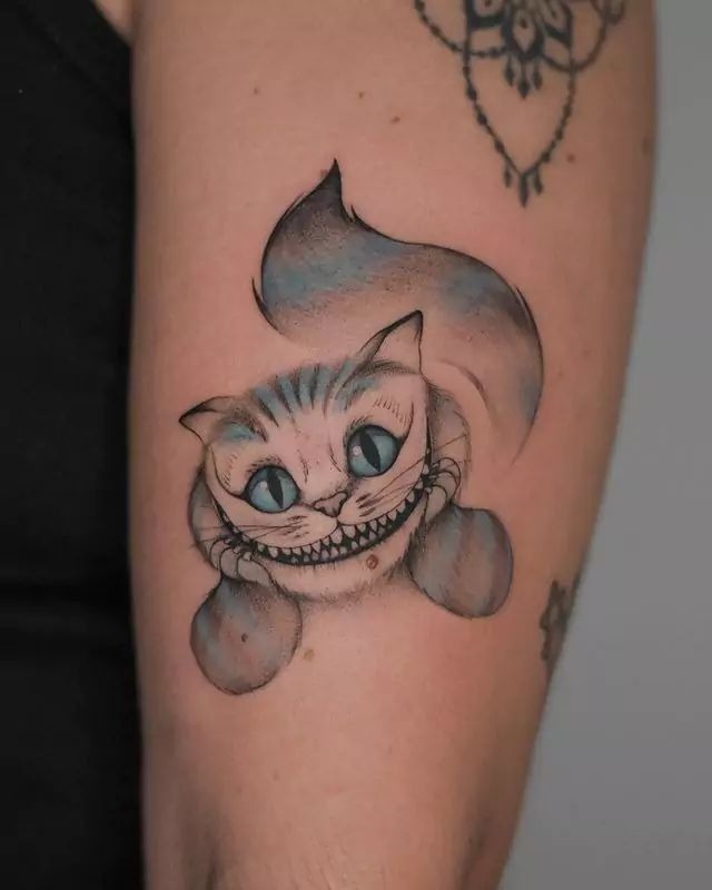 Soft Blue-Toned Cheshire Cat Tattoo Tattoo Design