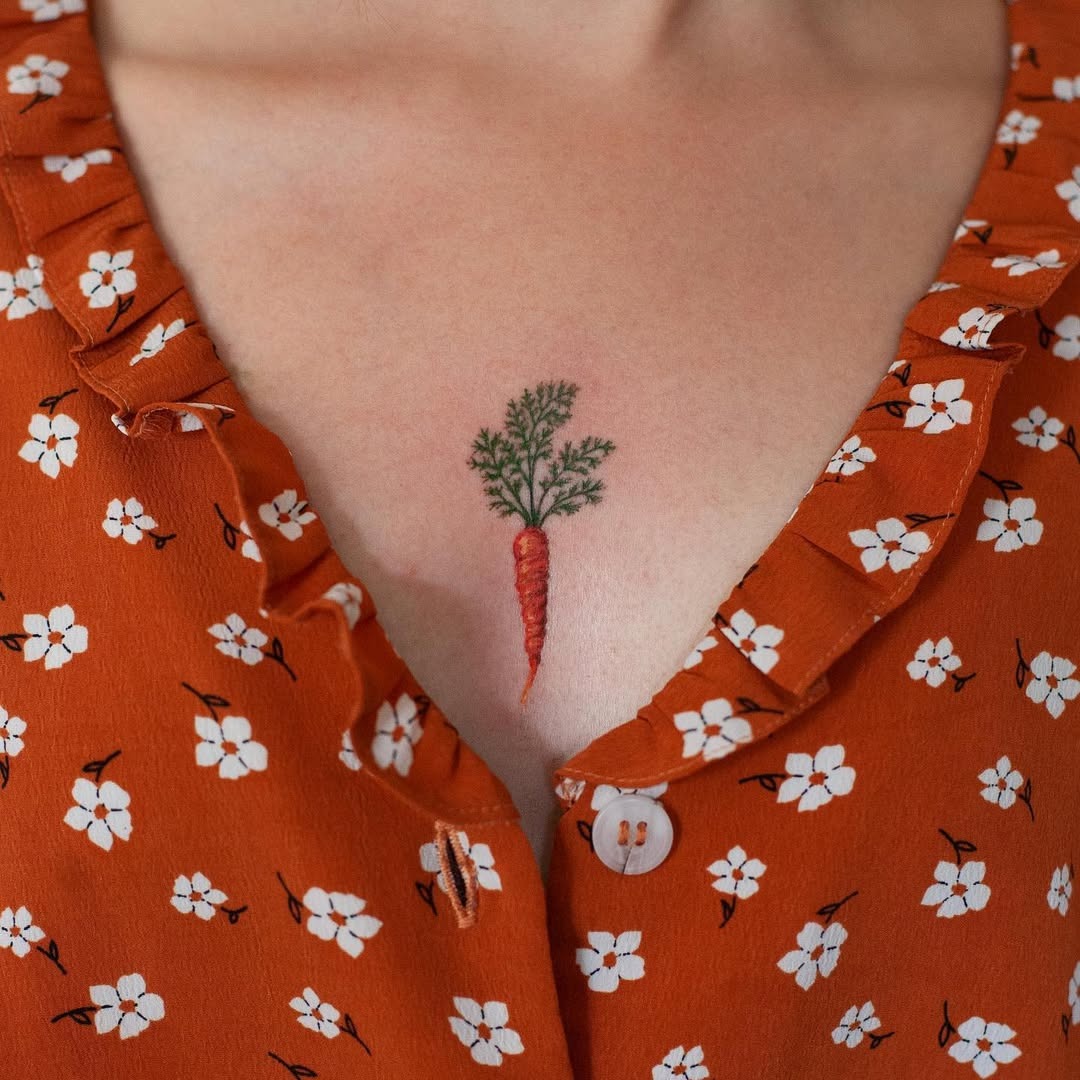 Charming carrot tattoo on the chest area Tattoo Design